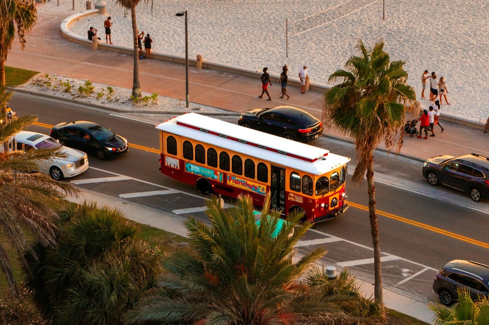 A tour bus driving down a street in Miami Beach, Florida