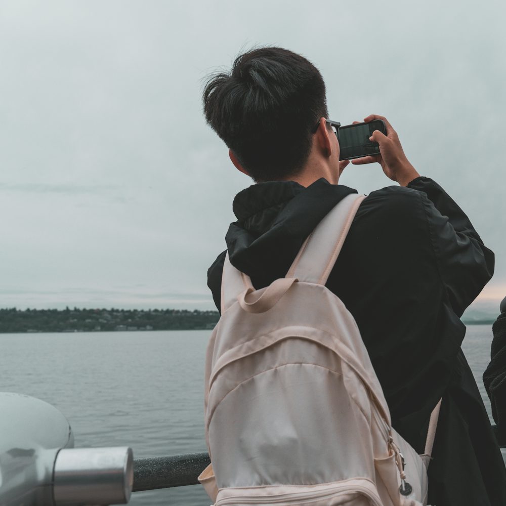 Traveler photographing Biscayne Bay from the waterfront